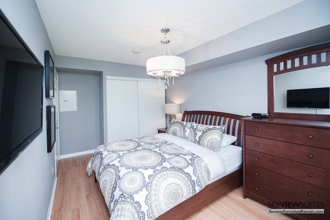 5940 Yonge Street furnished apartment toronto bedroom with mounted television and drawer