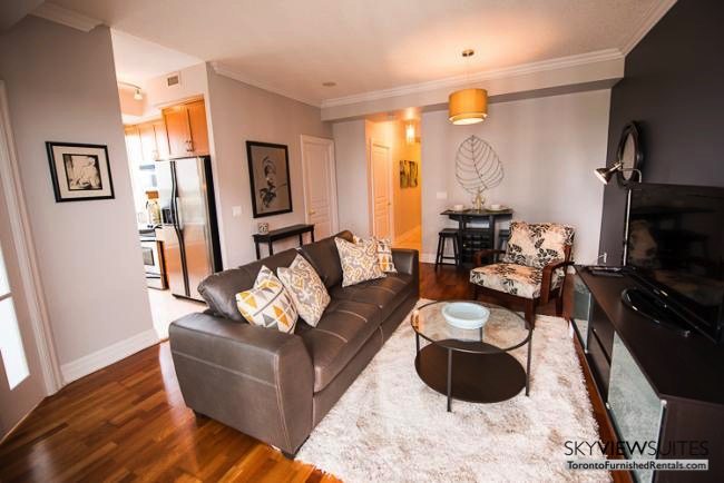 furnished rentals toronto lakeshore west living room with television and kitchen entrance