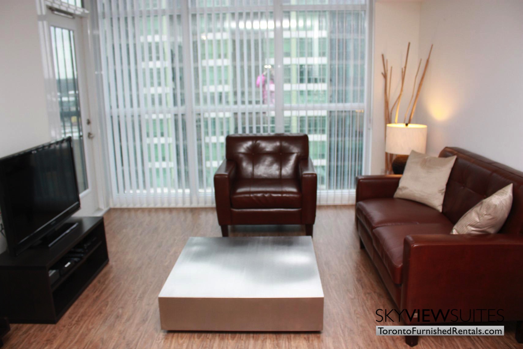 Leslie and Sheppard furnished suites toronto red leather couch