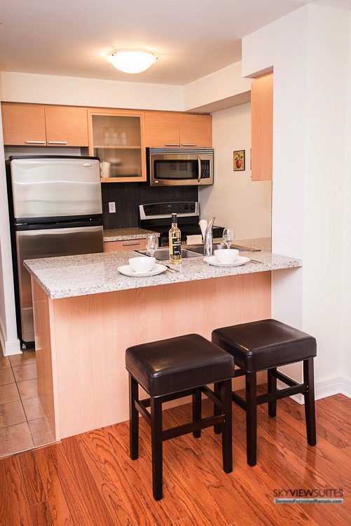 corporate rentals toronto Avondale kitchen with barstools