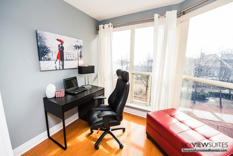 serviced apartments toronto marina del ray desk with laptop and red ottoman