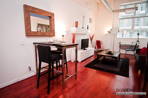 Church and Dundas toronto corporate housing sunken living room with televisio, table, and couch