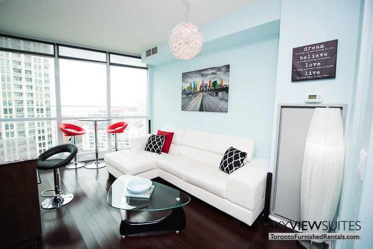 furnished suites toronto Neptune living room with red barstools