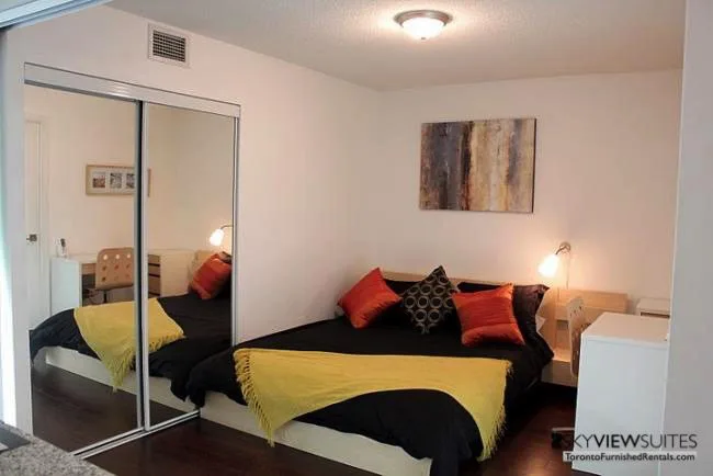 corporate housing toronto 1 Scott Street bedroom with mirror and desk