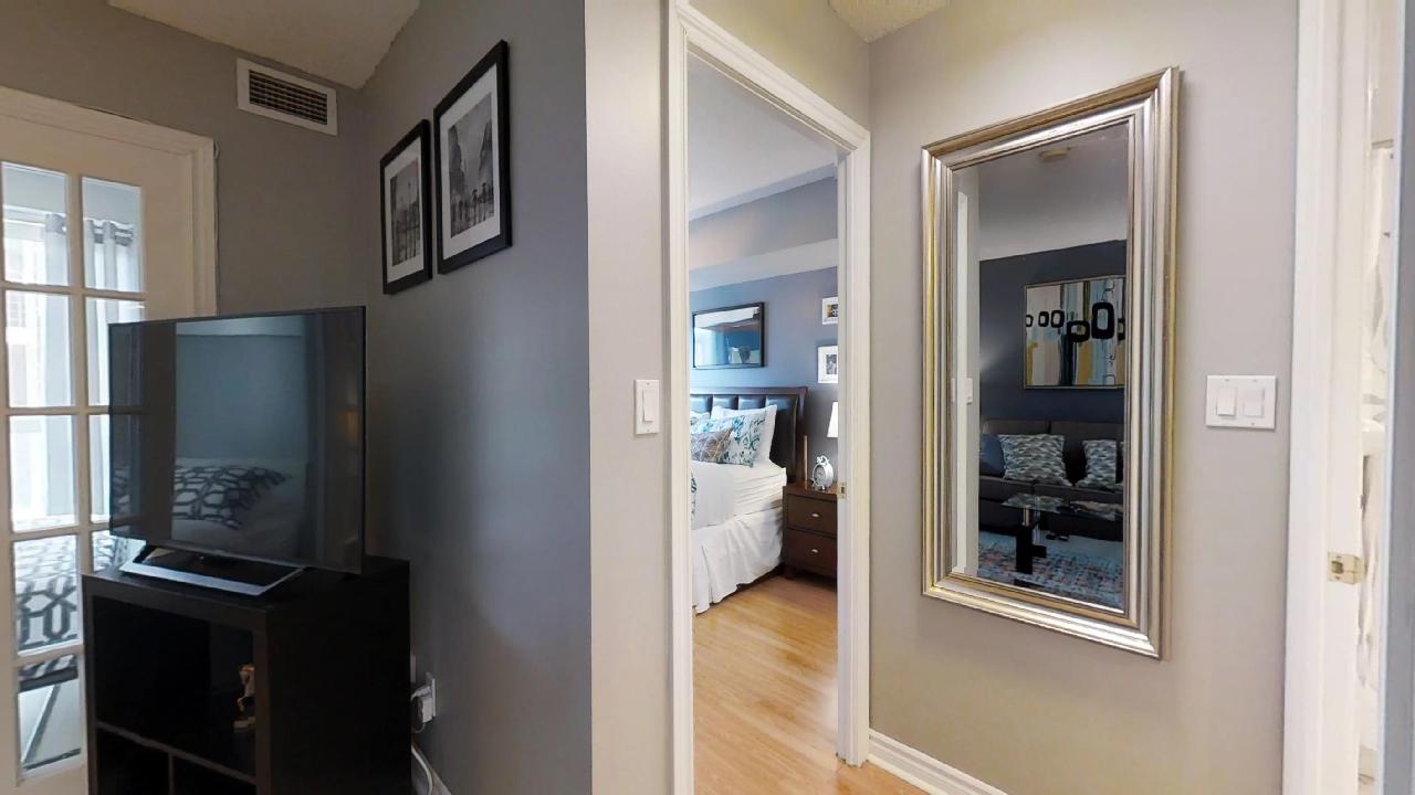 view of bedroom from living room furnished apartment near queen and university, toronto