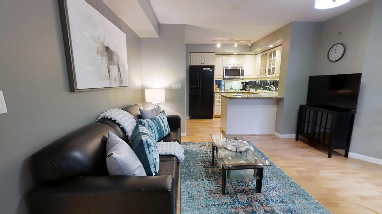 view of living room and kitchen at 140 simcoe condo