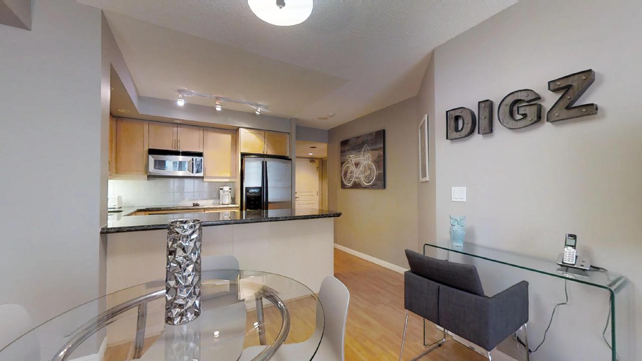 The living room and kitchen of a Toronto furnished apartment at Simcoe and Richmond