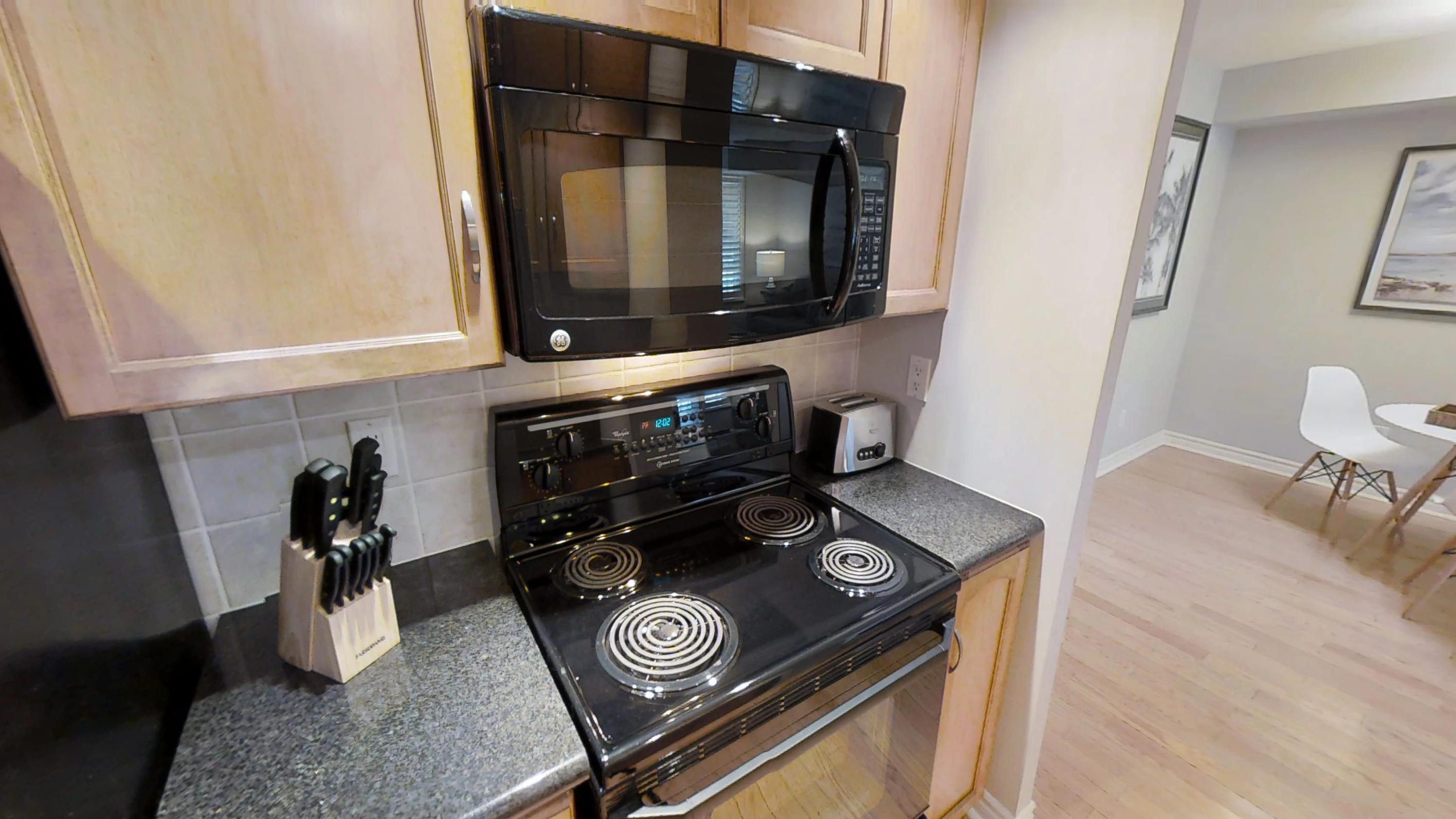 the oven and microwave in a furnished apartment in downtown Toronto, near Wellington and John