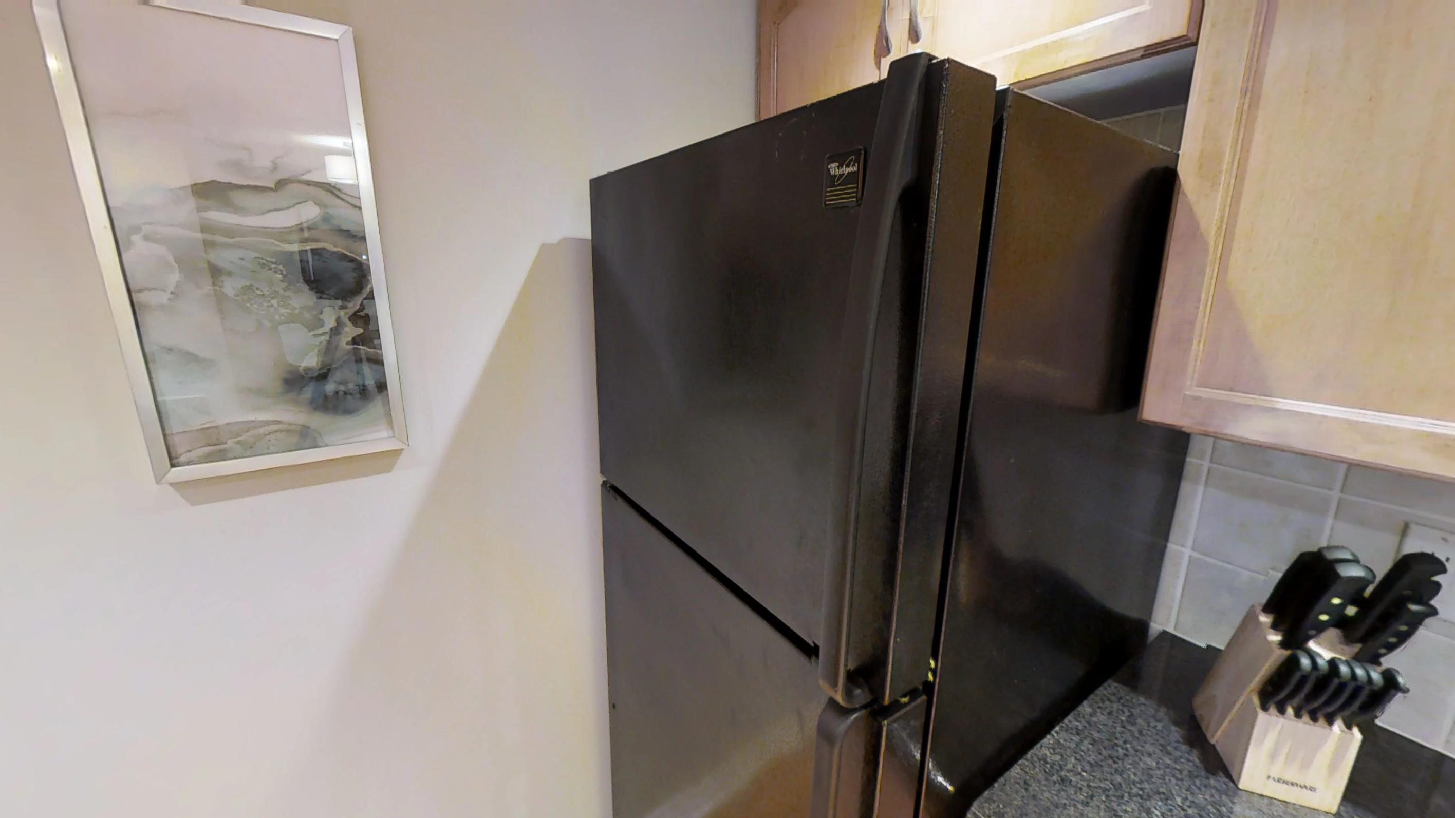a black fridge in a toronto corporate stay suite, near Wellington and Blue Jays Way