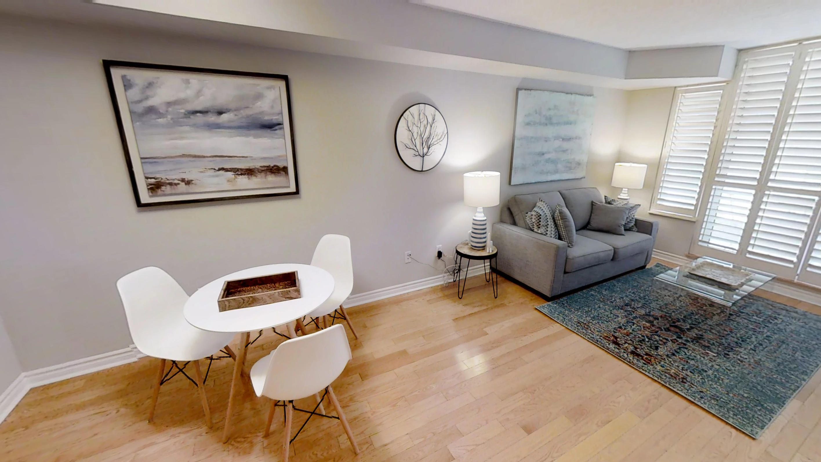 dining table and couch in living space of Sky View Suites' Icon G furnished apartment