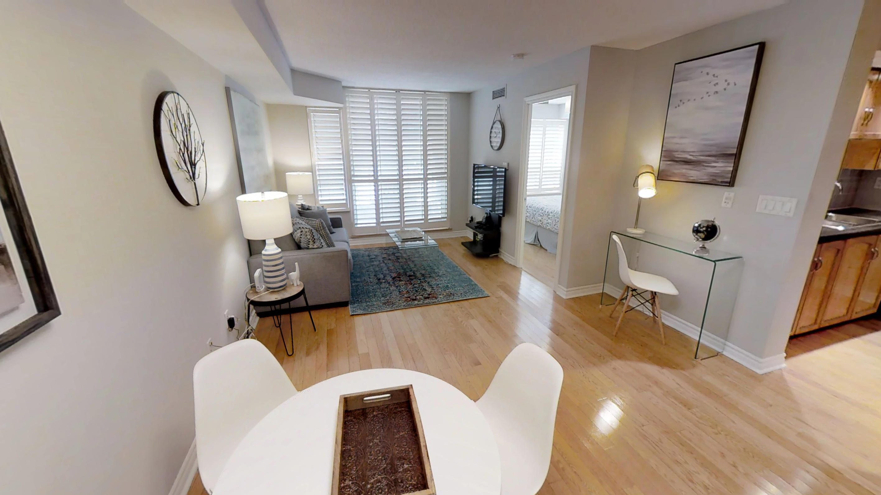 a view, from the dining table, of the rest of this serviced apartments furnished living space, located near the Air Canada Centre, in downtown Toronto.