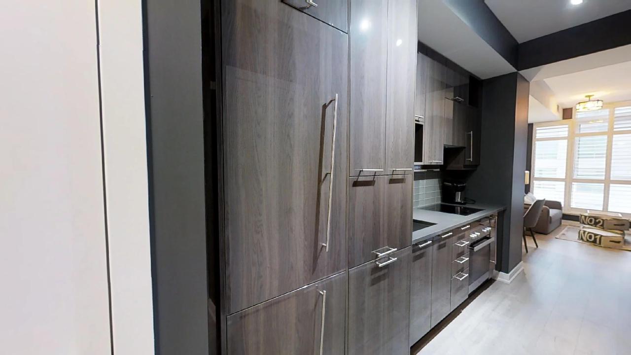 the wooden door to a fridge in a toronto furnished apartment