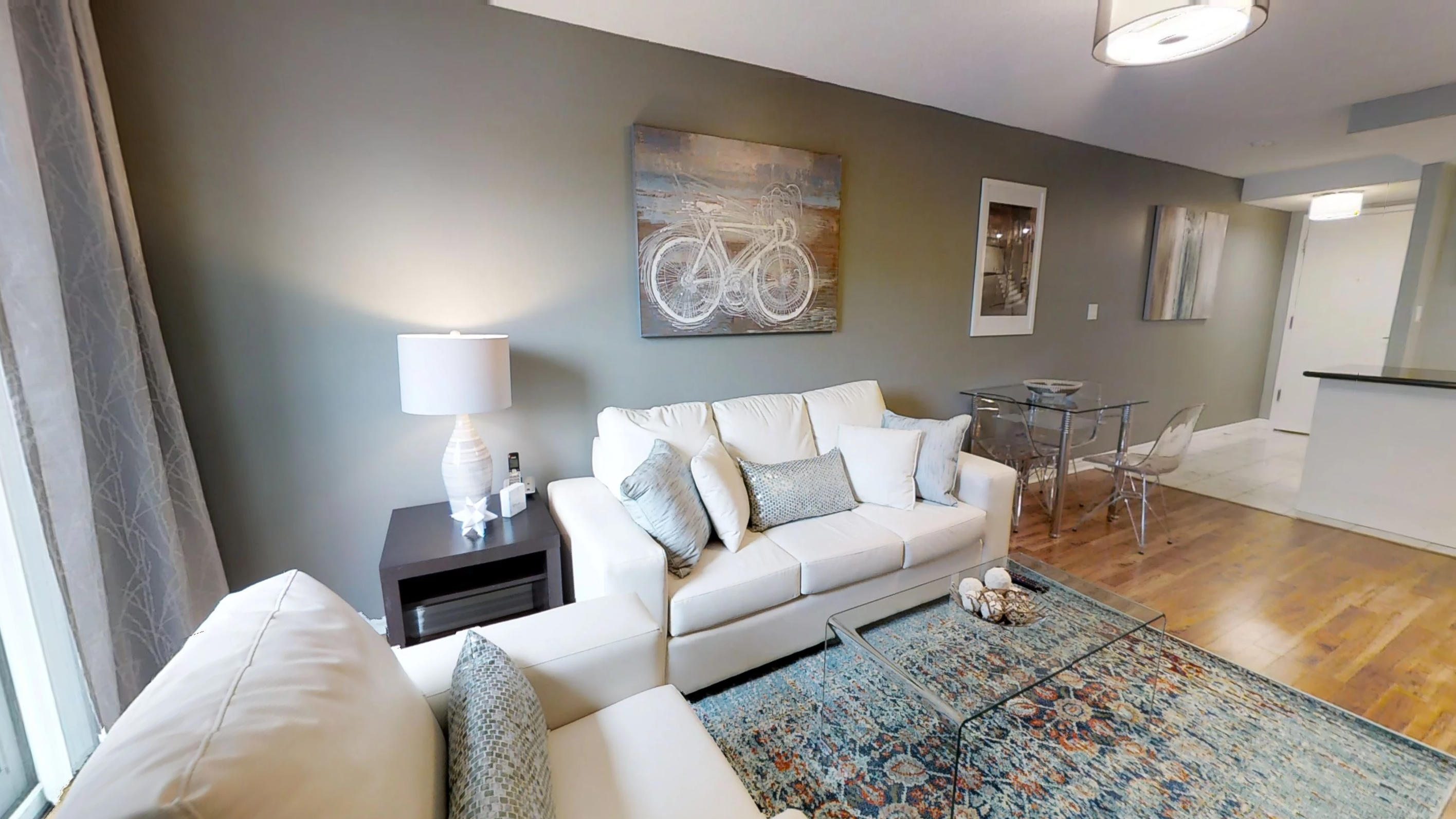 the living room and kitchen in a Toronto furnished apartment at Queen and Simcoe Streets